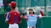 Aimar Lima (1) celebra parado en primera base después de conectar un hit en el juego de este domingo contra Cuba. (AP Photo/Tom E. Puskar)